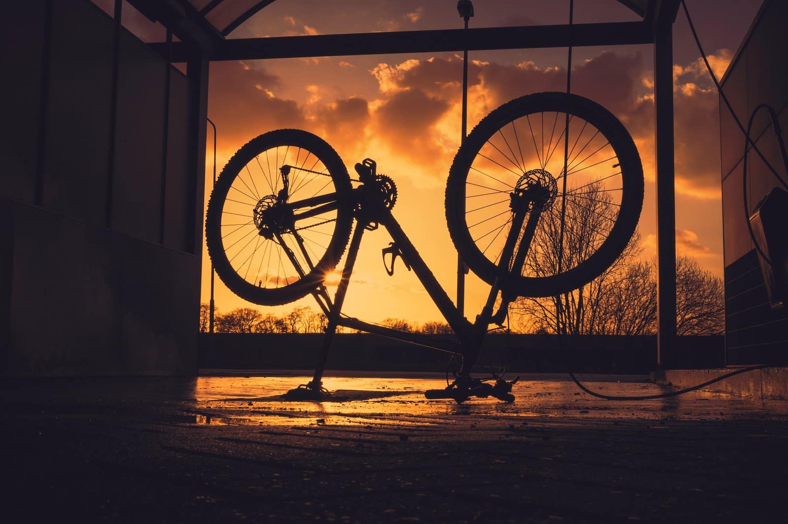 Washing MTB Bike At Sunset